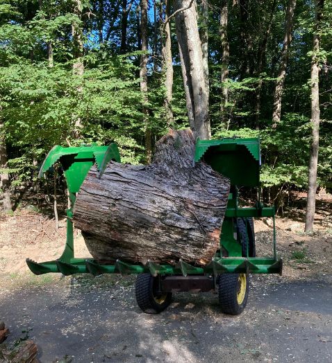 tractor carrying a log from a cut tree stroudsburg pa